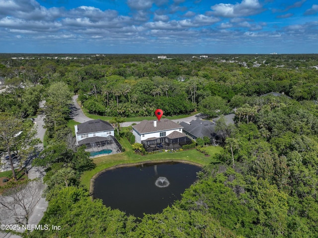 aerial view featuring a wooded view and a water view