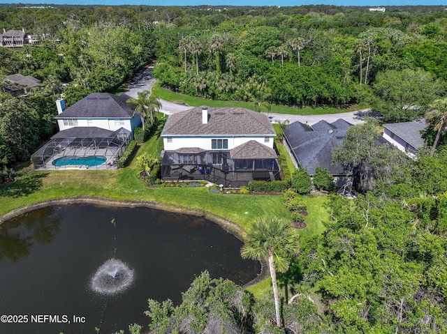 drone / aerial view with a water view and a view of trees