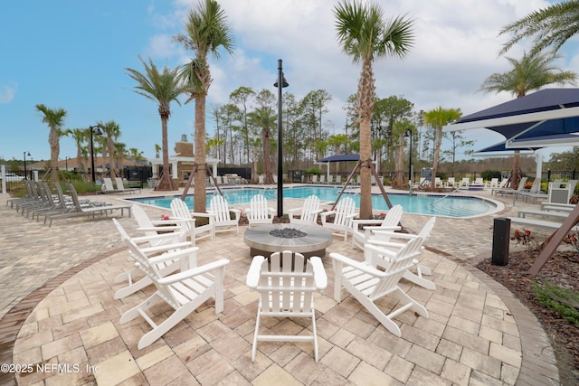 102 Fairlake Cir, Saint Augustine, FL 32092 - community pool featuring a fire pit, a patio area, and fence