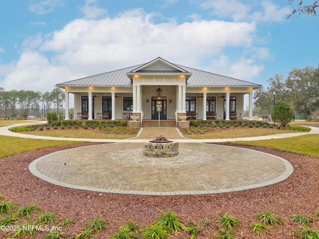 102 Fairlake Cir, Saint Augustine, FL 32092 - view of front facade featuring a porch, metal roof, a front yard, and a standing seam roof