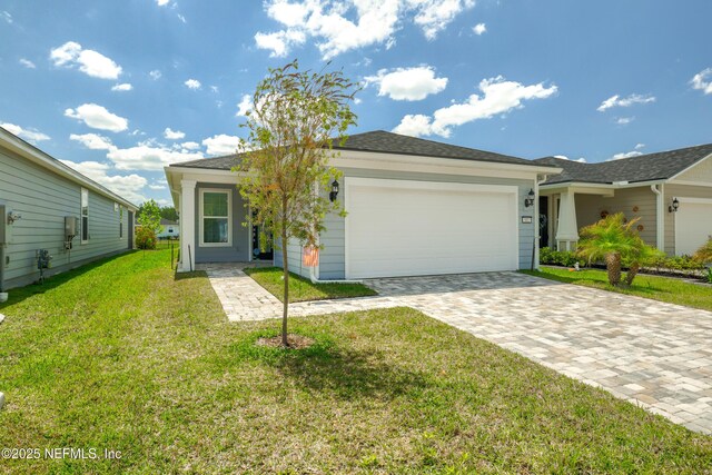 102 Fairlake Cir, Saint Augustine, FL 32092 - view of front of home with an attached garage, a front lawn, and decorative driveway