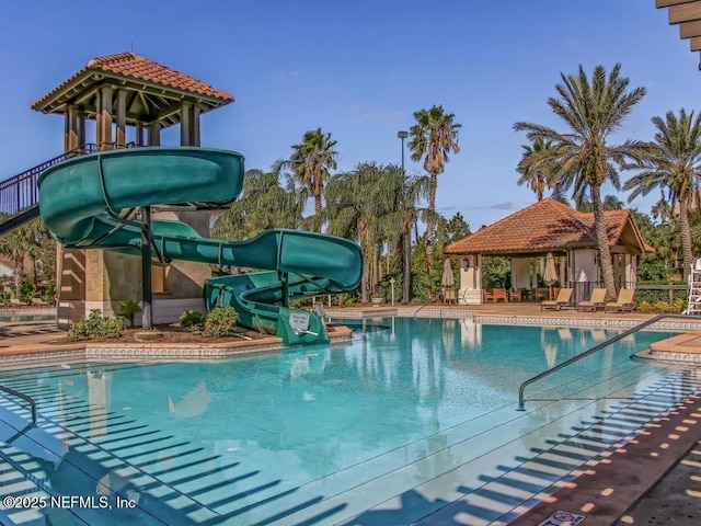 pool featuring a patio, a gazebo, and a water slide