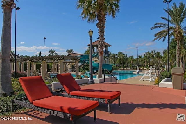 view of patio / terrace with a community pool and a pergola