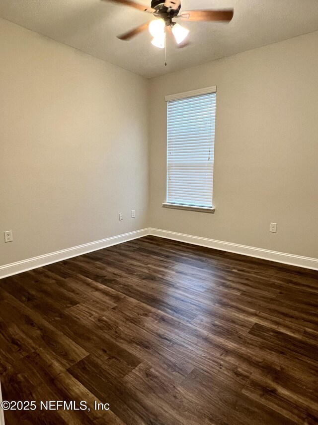 2714 Las Calinas Blvd, Saint Augustine, FL 32095 - spare room with baseboards, dark wood-style floors, and ceiling fan