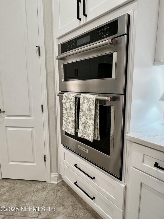 2714 Las Calinas Blvd, Saint Augustine, FL 32095 - room details featuring white cabinets, double oven, and light stone countertops