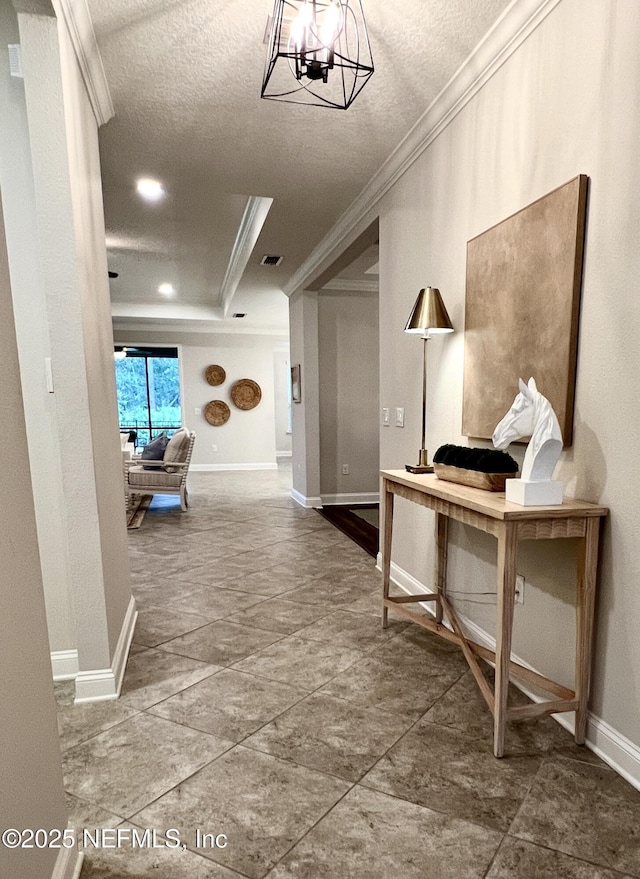 2714 Las Calinas Blvd, Saint Augustine, FL 32095 - hallway with crown molding, baseboards, a tray ceiling, and visible vents