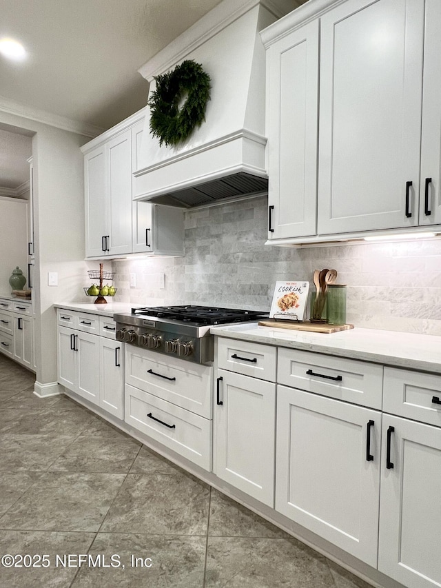 2714 Las Calinas Blvd, Saint Augustine, FL 32095 - kitchen featuring white cabinetry, stainless steel gas stovetop, custom range hood, and ornamental molding