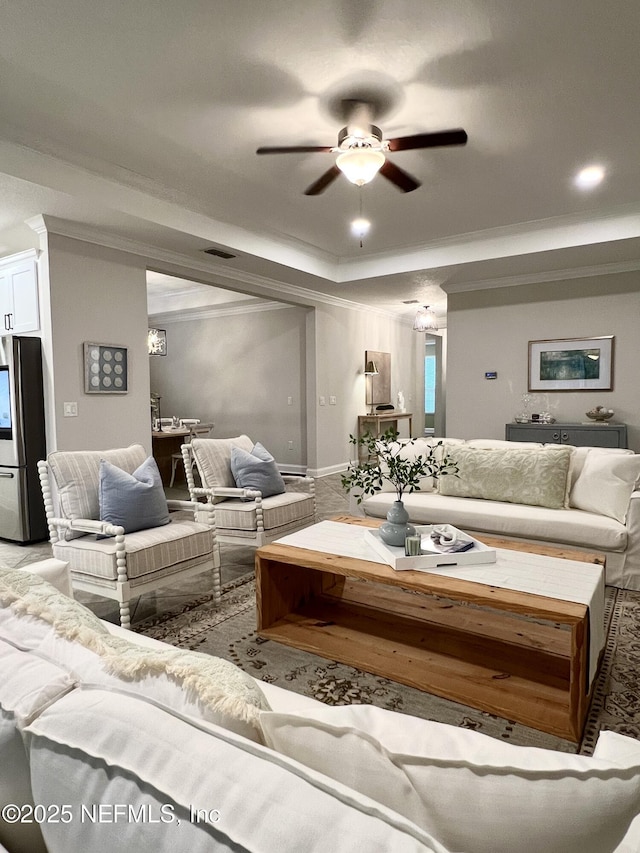 2714 Las Calinas Blvd, Saint Augustine, FL 32095 - living area featuring a tray ceiling, visible vents, ornamental molding, and a ceiling fan