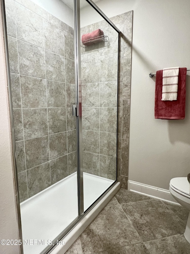 2714 Las Calinas Blvd, Saint Augustine, FL 32095 - bathroom featuring baseboards, toilet, and a shower stall