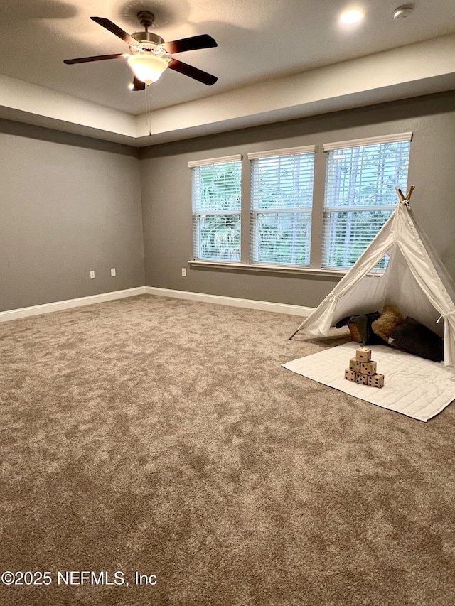 2714 Las Calinas Blvd, Saint Augustine, FL 32095 - interior space featuring carpet, baseboards, a tray ceiling, and ceiling fan