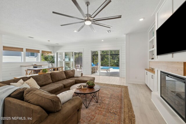 280 Quail Vista Dr, Ponte Vedra, FL 32081 - living area with light wood-type flooring, a healthy amount of sunlight, a ceiling fan, and visible vents