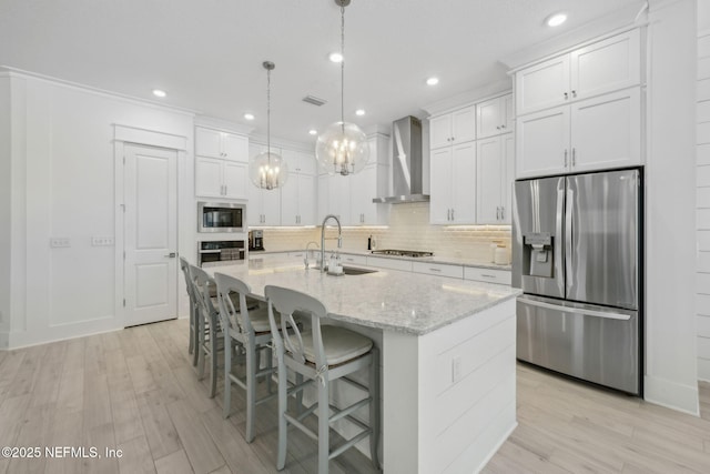 280 Quail Vista Dr, Ponte Vedra, FL 32081 - kitchen with wall chimney exhaust hood, tasteful backsplash, light wood-type flooring, a sink, and stainless steel appliances