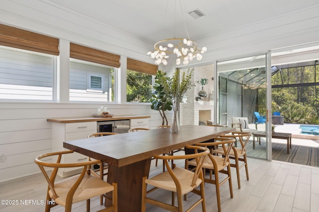 280 Quail Vista Dr, Ponte Vedra, FL 32081 - dining area with light wood-style floors, an inviting chandelier, wine cooler, and visible vents