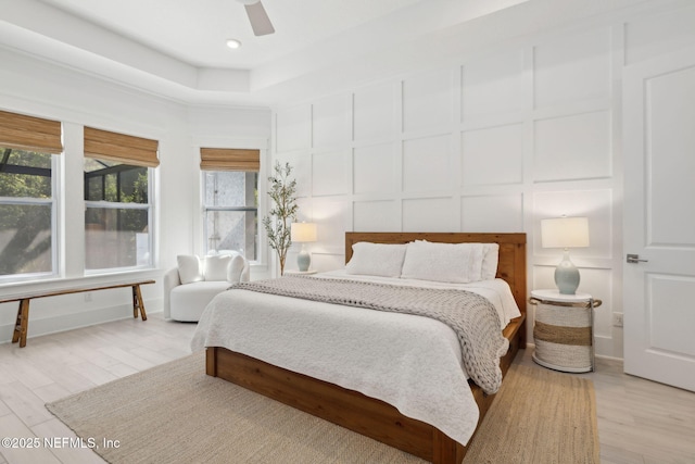280 Quail Vista Dr, Ponte Vedra, FL 32081 - bedroom featuring a ceiling fan, light wood-style floors, a decorative wall, and multiple windows