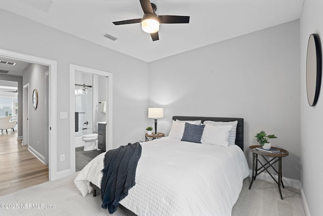 bedroom with baseboards, a ceiling fan, connected bathroom, carpet floors, and visible vents