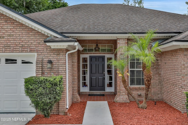 12847 Swamp Owl Ln, Jacksonville, FL 32258 - entrance to property featuring roof with shingles, an attached garage, and brick siding