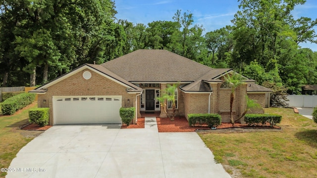 12847 Swamp Owl Ln, Jacksonville, FL 32258 - view of front of house featuring concrete driveway, an attached garage, brick siding, and a shingled roof