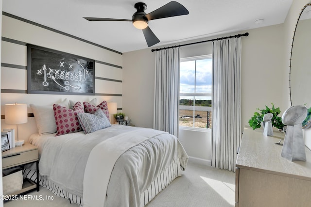 bedroom featuring a ceiling fan and light carpet