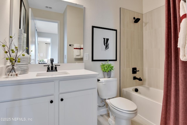 bathroom with toilet, vanity, shower / tub combo, and visible vents
