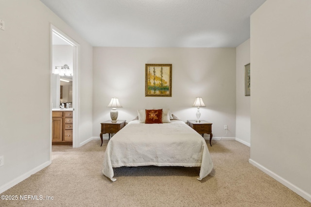 9831 Del Webb Pkwy Unit 3107, Jacksonville, FL 32256 - bedroom featuring light carpet, ensuite bath, and baseboards