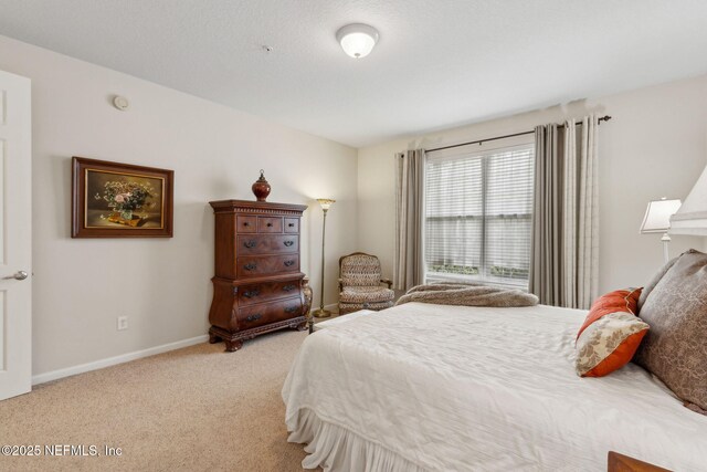 9831 Del Webb Pkwy Unit 3107, Jacksonville, FL 32256 - bedroom with baseboards and light colored carpet