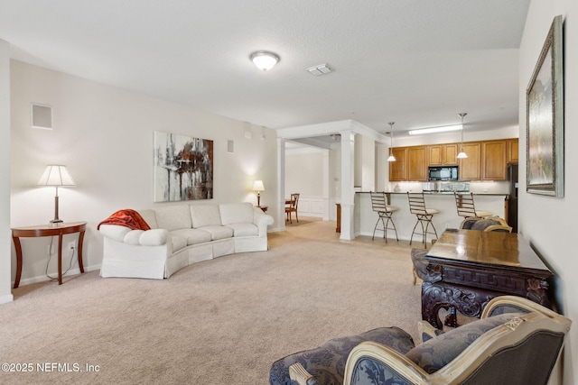 9831 Del Webb Pkwy Unit 3107, Jacksonville, FL 32256 - living area with visible vents, baseboards, and light carpet