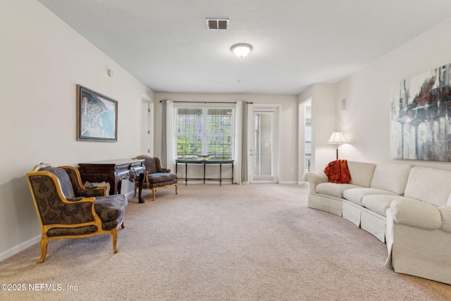 9831 Del Webb Pkwy Unit 3107, Jacksonville, FL 32256 - carpeted living room featuring visible vents, baseboards, and a textured ceiling