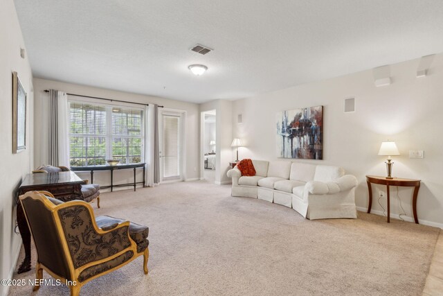 9831 Del Webb Pkwy Unit 3107, Jacksonville, FL 32256 - carpeted living area with visible vents and baseboards