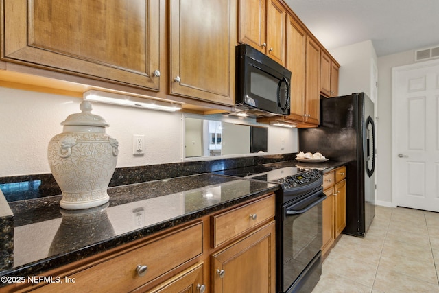 9831 Del Webb Pkwy Unit 3107, Jacksonville, FL 32256 - kitchen featuring dark stone countertops, light tile patterned flooring, visible vents, brown cabinets, and black appliances