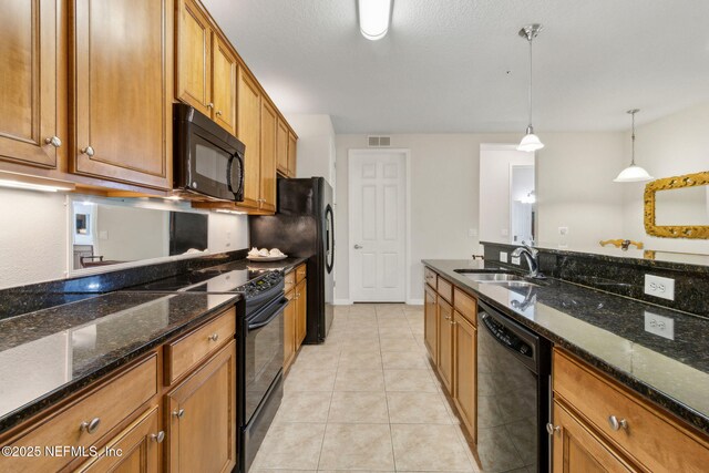 9831 Del Webb Pkwy Unit 3107, Jacksonville, FL 32256 - kitchen with visible vents, a sink, brown cabinetry, black appliances, and pendant lighting