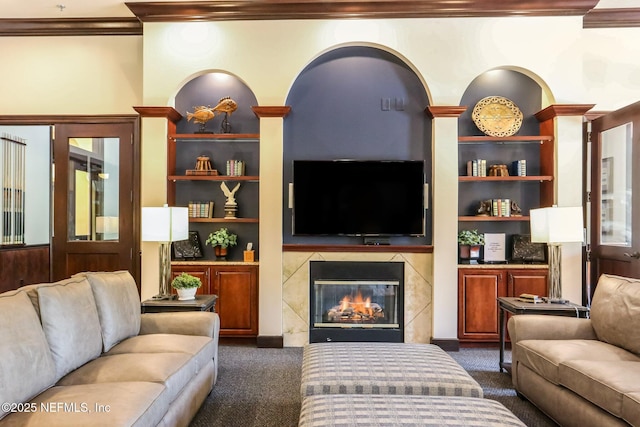 9831 Del Webb Pkwy Unit 3107, Jacksonville, FL 32256 - living area with dark carpet, a premium fireplace, built in features, and ornamental molding