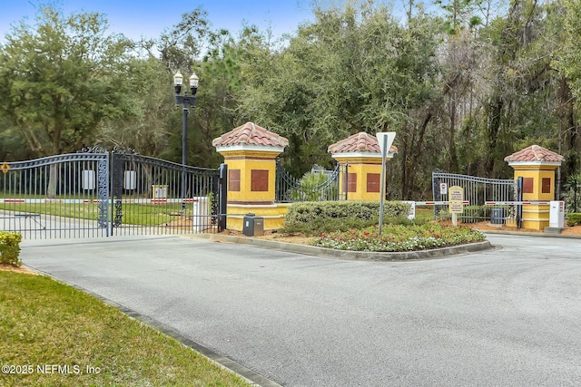 9831 Del Webb Pkwy Unit 3107, Jacksonville, FL 32256 - view of road with curbs, a gated entry, and a gate