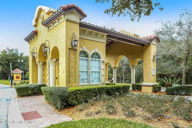 9831 Del Webb Pkwy Unit 3107, Jacksonville, FL 32256 - exterior space featuring a tiled roof and stucco siding