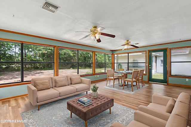 54223 Lisa Dr, Callahan, FL 32011 - living area with baseboards, healthy amount of natural light, ceiling fan, ornamental molding, and wood finished floors