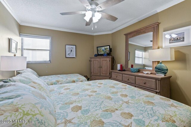 bedroom featuring a textured ceiling, ornamental molding, multiple windows, and a ceiling fan
