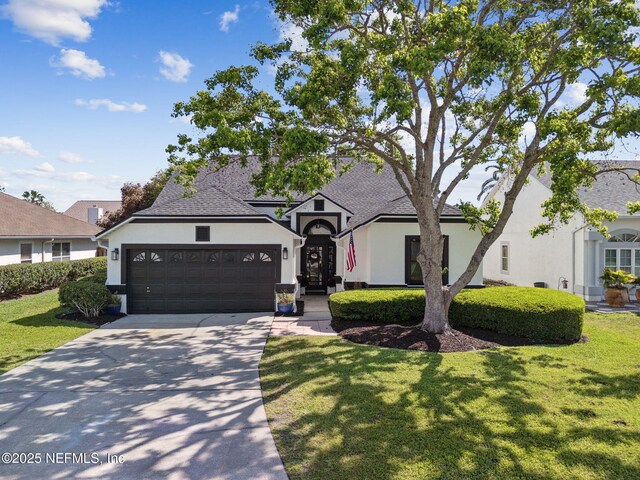 185 Crosscove Cir, Ponte Vedra Beach, FL 32082 - view of front facade featuring a garage, stucco siding, driveway, and a front yard
