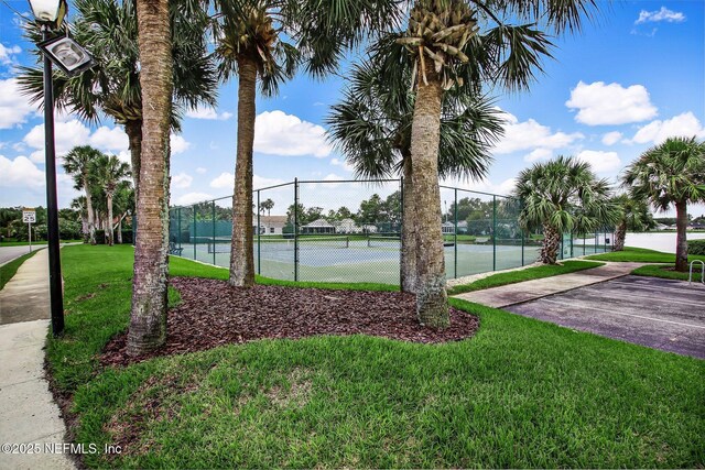 185 Crosscove Cir, Ponte Vedra Beach, FL 32082 - view of tennis court with a yard and fence