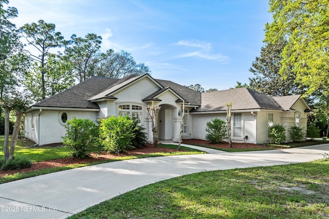 1952 Quaker Ridge Dr, Green Cove Springs, FL 32043 - ranch-style home with a shingled roof, stucco siding, and a front lawn