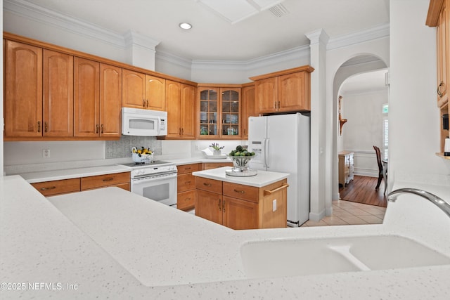 1952 Quaker Ridge Dr, Green Cove Springs, FL 32043 - kitchen with arched walkways, ornamental molding, a sink, and white appliances