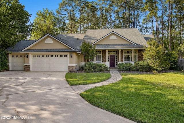 view of front of home with stone siding, an attached garage, concrete driveway, a front yard, and stucco siding