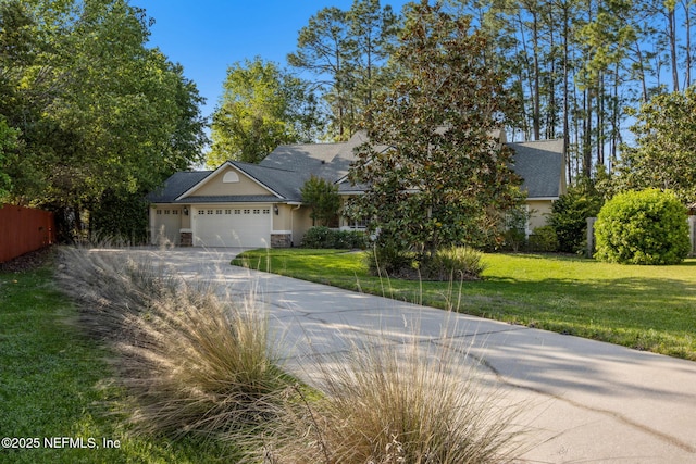 view of front of property with driveway, an attached garage, stone siding, and a front yard