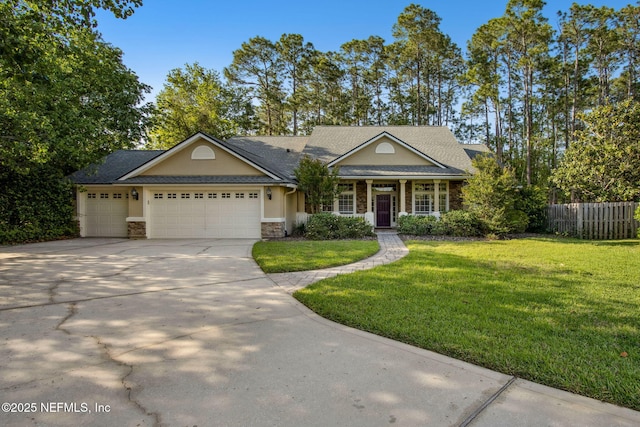view of front of home featuring driveway, fence, a garage, a front lawn, and stucco siding