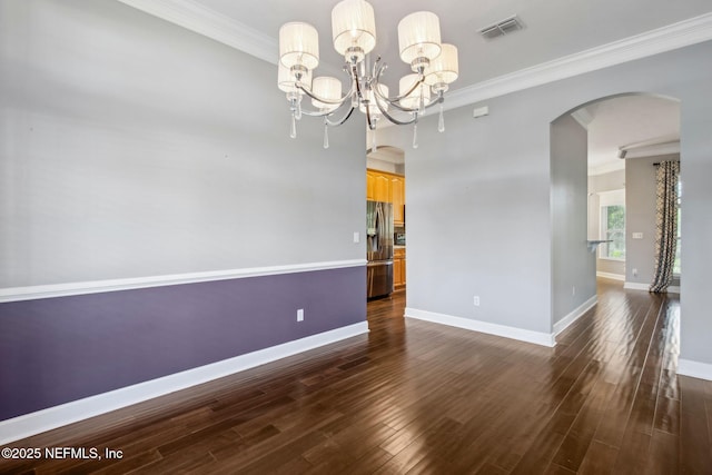 unfurnished room with ornamental molding, dark wood finished floors, arched walkways, and visible vents