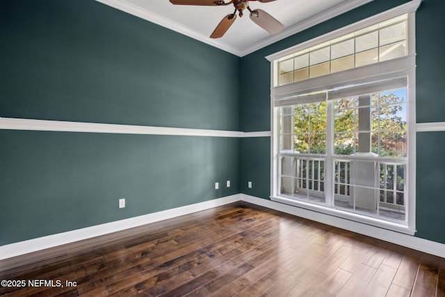 unfurnished room with dark wood-style floors, crown molding, baseboards, and a ceiling fan