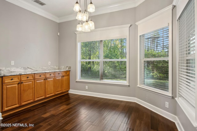 unfurnished dining area featuring ornamental molding, baseboards, a chandelier, dark wood finished floors, and visible vents