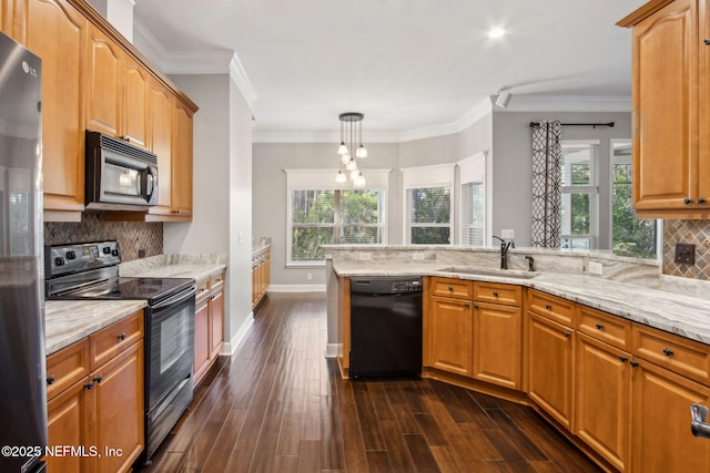 kitchen featuring a sink, light stone countertops, black appliances, decorative backsplash, and dark wood-type flooring