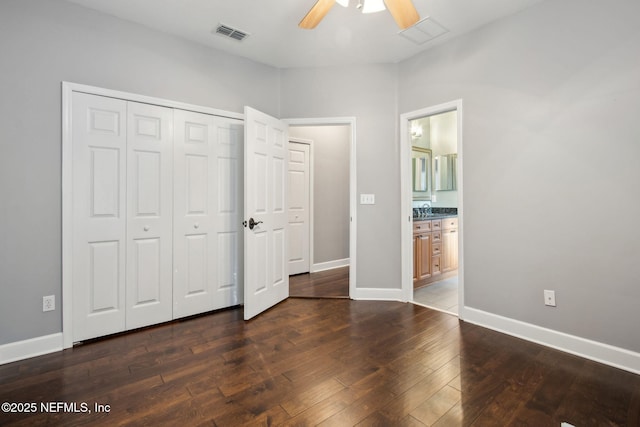 unfurnished bedroom with a closet, visible vents, baseboards, ceiling fan, and dark wood-style floors