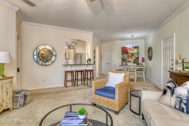 1825 Vista Cove Rd, Saint Augustine, FL 32084 - living area with crown molding, baseboards, arched walkways, and light colored carpet