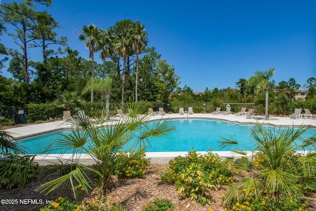 1825 Vista Cove Rd, Saint Augustine, FL 32084 - community pool with fence, a patio, and view of wooded area