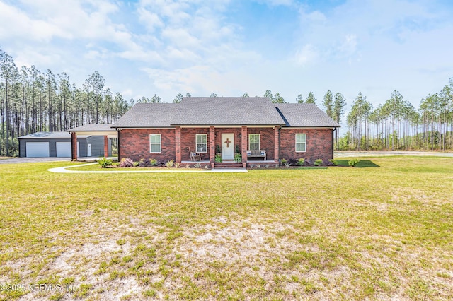 ranch-style home with brick siding, a front lawn, an outdoor structure, and covered porch